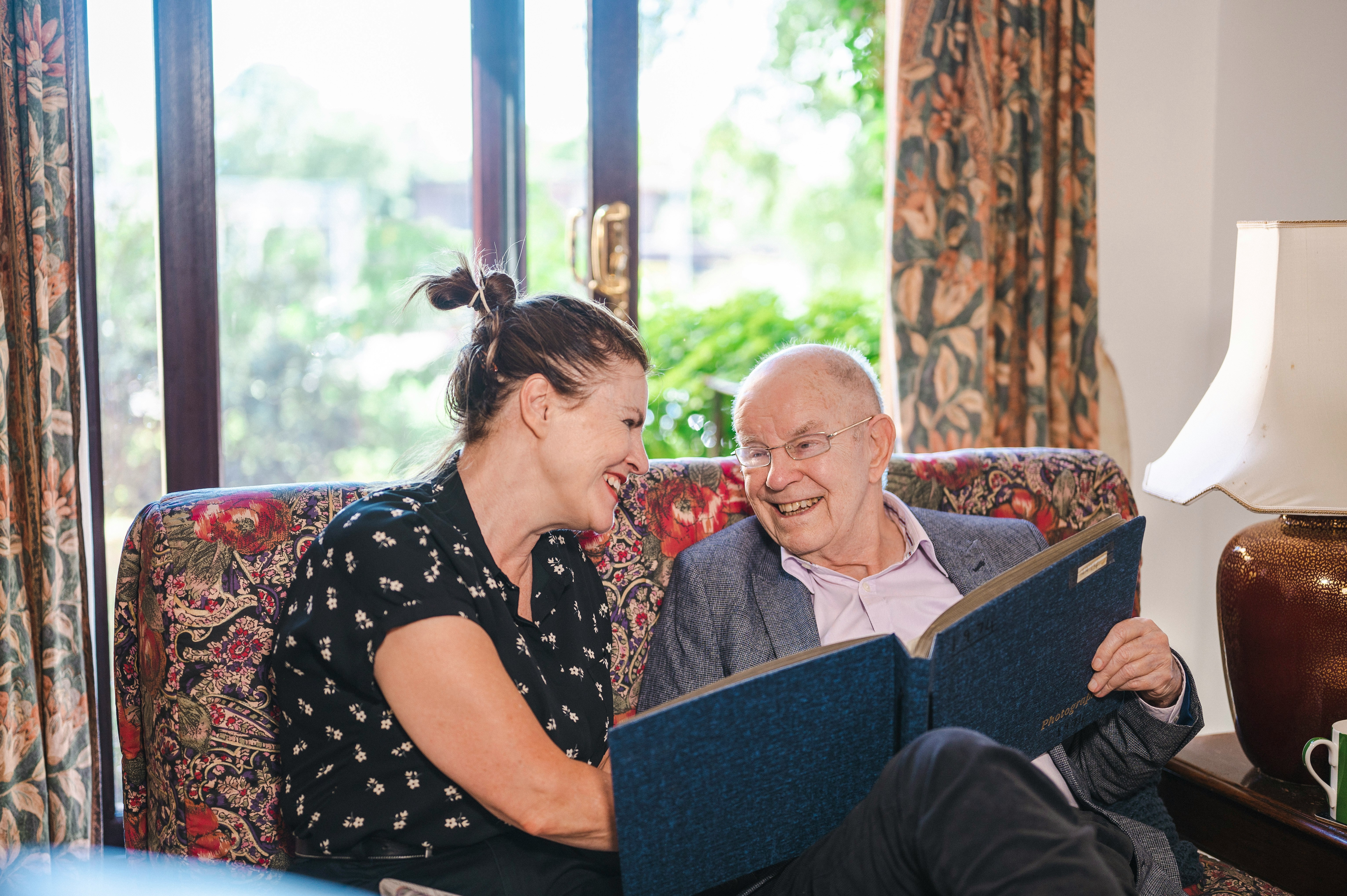 Care worker assisting an older person with a smartphone